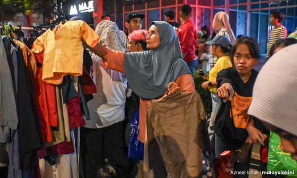 PHOTO ESSAY | Used clothing brings Raya cheer to urban poor